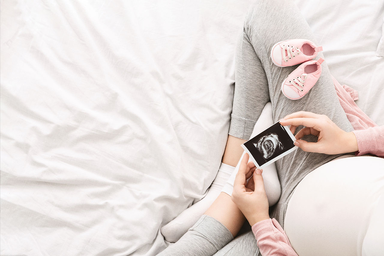 A,Pregnant,Woman,Lounges,On,A,Bed,In,The,Morning, PageImage Woman Ultrasound